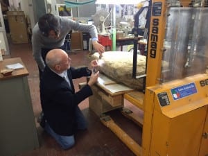 Scientists examine the Etruscan stele, weighing about 500 pounds and nearly four feet tall by more than two feet wide. (Credit: Mugello Valley Project)