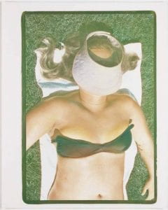 Visor, 1977, Photograph of the upper body of a sunbathing woman with her head covered by a visor.