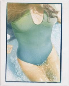 Mich in Pool, 1978, Photograph of the midsection of a sunbathing woman wearing a green swimsuit.