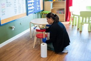 Student cleaning classroom
