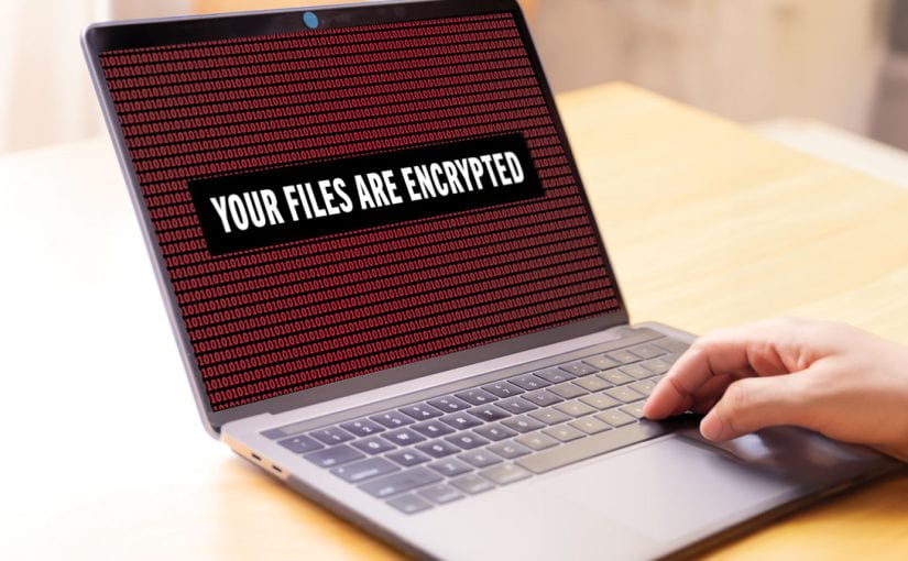Laptop with the warning, 'YOUR FILES ARE ENCRYPTED.'