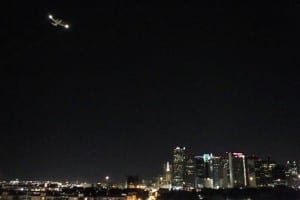 A plane flew over central Dallas as part of aerial spraying efforts last summer to combat mosquitoes carrying the West Nile virus. (Credit: Dallas Morning News)
