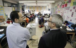 In a March 3, 2011 photo, teacher Josh Krinsky, left, and Principal Brett Kimmel get together in Krinsky's Global History class at the Washington Heights Expeditionary Learning School in New York. (AP Photo/Richard Drew)