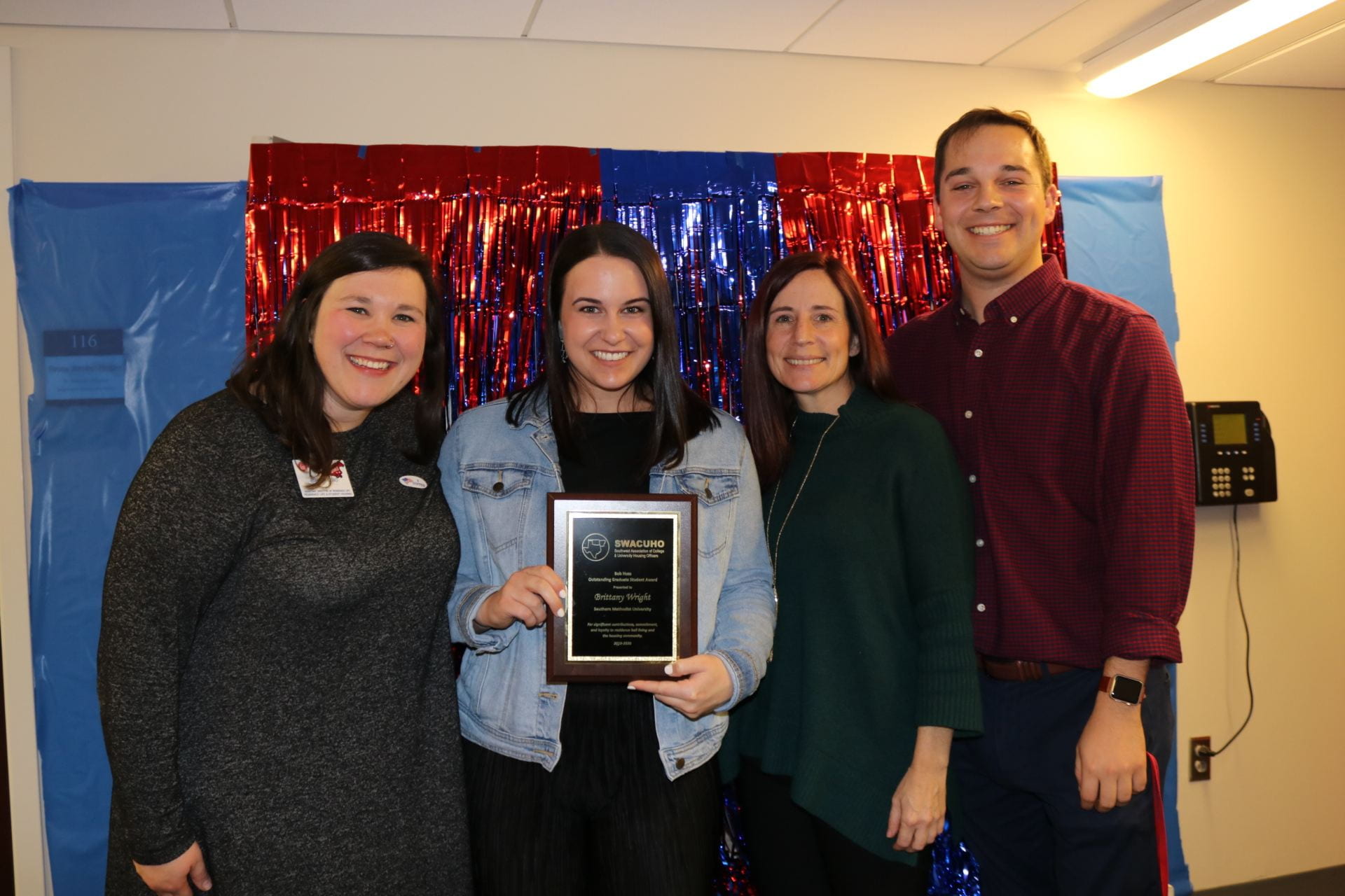 Brittany Wright posing for picture with her SWACUHO Award. Left to right, Amanda Bobo, Brittany Wright, Jennifer Post, and Nate Faust.