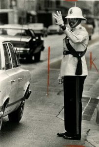 Photograph Lawrence Harrison directing Dallas traffic, May 1975
