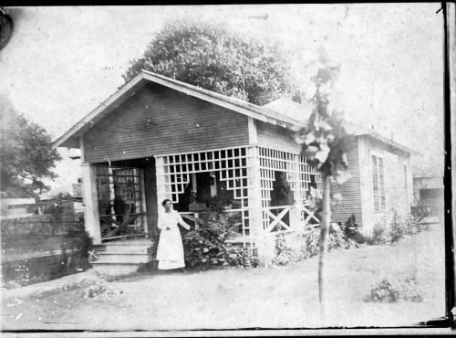 Unidentified African-American woman on porch of home, undated
