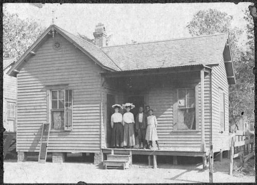 Unnamed African-American family poses for a photograph on the porch of a Dallas home, 1910